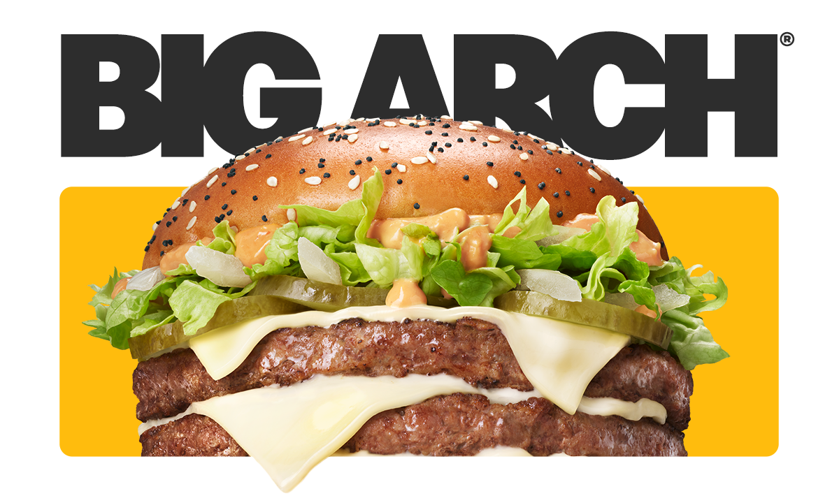 Grafika: Na pierwszym planie duży burger na żółtym tle, lekko nachodzący na czarny, mocno pogrubiony napis "BIG ARCH" na białym tle. Burger BIG ARCH składa się z dwóch kotletów wołowych, przełożonych trzema plasterkami białego sera cheddar, z dodatkiem pr